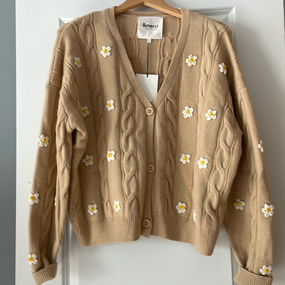 New &merci tan sweater with daisies.